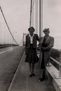 People posing with bridges