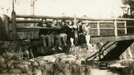 People posing with bridges